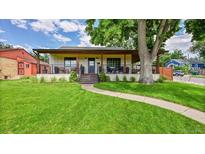 Charming single-story home featuring a welcoming front porch and lush green lawn at 2990 S Sherman St, Englewood, CO 80113