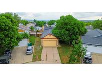 Charming single-Gathering home with well-kept lawn, mature trees, and solar panels on the roof at 7961 Jared Way, Littleton, CO 80125