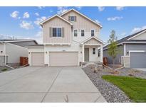 Inviting two-story home featuring a two car garage, neutral colors, and a well-maintained front yard at 45922 Gentry Ave, Bennett, CO 80102