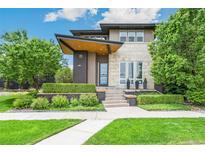 Stunning modern home with unique architectural details and well-manicured landscaping at 9244 E 37Th Ave, Denver, CO 80238
