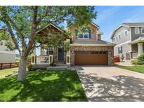 Charming two-story home showcasing a well-maintained front yard, inviting porch, and a brick two-car garage at 3912 Miners Candle Pl, Castle Rock, CO 80109