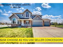 Charming two-story home with a three-car garage, inviting porch, and beautifully maintained lawn at 16680 Stroilway St, Hudson, CO 80642