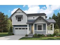 Charming two-story home featuring a covered porch, a two-car garage, and a well-manicured lawn at 8155 Butte Creek Street St, Littleton, CO 80125