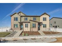 Modern two-story townhome with landscaped front yard and neutral color palette at 1236 S Algonquian St, Aurora, CO 80018