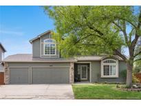 Charming two-story home featuring a well-manicured lawn, mature tree, and a two-car garage at 3418 Elk Ct, Broomfield, CO 80020