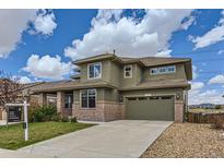 Charming two-story home with brick accents, a two car garage, and well-maintained landscaping at 4406 Sidewinder Loop, Castle Rock, CO 80108