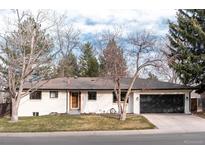 Charming single-story home featuring a well-maintained lawn and an attached two-car garage at 3004 S Niagara Way, Denver, CO 80224