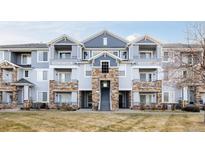 Inviting three-story building with stone accents and landscaping at 5255 Memphis St # 822, Denver, CO 80239