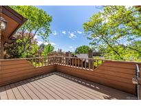 Exterior view of a private deck surrounded by mature trees offering privacy and an outdoor space for relaxation at 9400 E Iliff Ave # 88, Denver, CO 80231