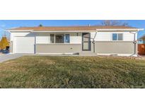Charming home featuring a well-maintained lawn, gray brick accents, and a cozy, inviting front entrance at 9120 Judson St, Westminster, CO 80031