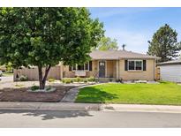Charming ranch-style home with manicured lawn, mature tree, and inviting front porch at 4780 E Montana Pl, Denver, CO 80222