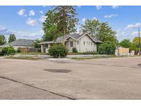 Charming corner lot home featuring a classic design, mature trees and lush landscaping at 4001 S Acoma St, Englewood, CO 80110