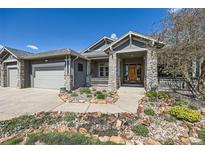 Charming home with stone accents, well-maintained landscaping, and a welcoming front porch at 4781 Mariposa Rd, Castle Rock, CO 80104