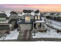 Two-story house with gray siding, white trim, and a covered porch at 3260 Jonquil St, Castle Rock, CO 80109