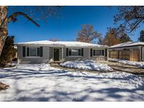 Charming one-story home with gray brick exterior, dark shutters and snow covered lawn at 80 Ingalls St, Lakewood, CO 80226
