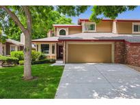 Charming two-story home with a well-maintained lawn and attached two-car garage at 8563 Redstone St, Highlands Ranch, CO 80126