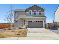 Charming two-story home featuring a well-maintained front yard and a spacious two-car garage at 27319 E 10Th Dr, Aurora, CO 80018