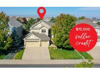 Charming two-story home with a well-manicured lawn, three car garage, and mature trees at 11973 Song Bird Hills St, Parker, CO 80138