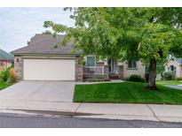 Brick ranch home with attached garage and landscaped yard at 2417 W 107Th Dr, Denver, CO 80234