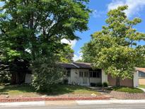 Charming single-story home with mature trees and a well-maintained front yard in a peaceful neighborhood at 6085 Simms St, Arvada, CO 80004