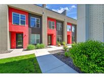 Modern townhome with red accents, large windows, and professional landscaping at 3044 Wilson Ct # 2, Denver, CO 80205