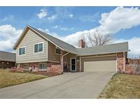 Charming two-story home with attached garage and well-maintained lawn at 7949 W Portland Ave, Littleton, CO 80128