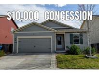 Charming single-story home with gray siding, well-maintained lawn, and an attached gray two-car garage at 370 Mesa Ave, Brighton, CO 80603