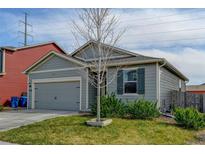 Charming single-story home with a well-maintained lawn, attached garage, and appealing exterior paint at 370 Mesa Ave, Brighton, CO 80603