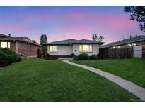 Charming single-story home with a well-manicured lawn and inviting walkway to the front door at 3640 Forest St, Denver, CO 80207