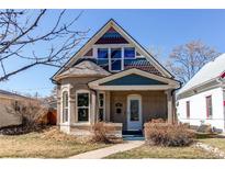 Charming home exterior featuring colorful decorative trim, a welcoming porch, and well-kept landscaping at 4337 Umatilla St, Denver, CO 80211