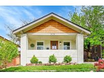 Charming home with a welcoming front porch, tidy landscaping, and a clean, painted brick exterior at 1474 S Emerson St, Denver, CO 80210