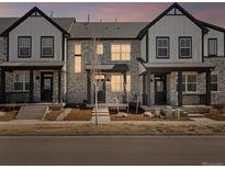 Charming townhouse showcasing stone facade, inviting porch and manicured front yard, perfect for relaxed living at 742 N Tempe St, Aurora, CO 80018
