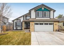 Charming two-story home with well-maintained lawn and attached two-car garage at 9094 W 103Rd Ave, Broomfield, CO 80021