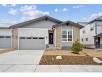 Charming single-Gathering home featuring a two-car garage, landscaped front yard, and neutral brick and siding at 6625 N Nepal St, Aurora, CO 80019