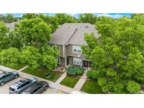 Charming two-story townhouse with lush landscaping and a well-maintained front yard, and convenient parking at 9632 W Chatfield Ave # C, Littleton, CO 80128