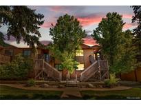 Inviting exterior showcasing wood siding, well-kept landscaping, and charming entrances in warm lighting at 9587 W 89Th Cir, Broomfield, CO 80021