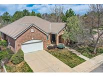 Beautiful brick home with a tile roof, well-manicured lawn, and attached two-car garage at 1 Silver Fox Dr, Greenwood Village, CO 80121