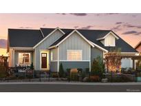 Charming home featuring a covered porch, professionally landscaped yard, and a cozy entrance at 332 Agoseris Way, Castle Rock, CO 80104