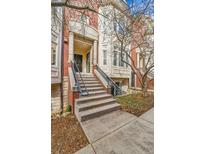 Inviting brick townhouse featuring a grand staircase and architectural columns at the entry at 45 Jackson St # C, Denver, CO 80206