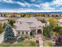 Beautiful single-Gathering home featuring an immaculate front yard and tile roof with mountain views at 774 Chamberlain Way, Highlands Ranch, CO 80126