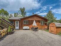 Cozy home with a welcoming front yard, dining set, and convenient storage shed at 12348 Quartz Spur, Conifer, CO 80433