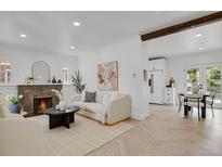 Bright living room with modern fireplace, hardwood floors, and updated finishes at 1455 Hudson St, Denver, CO 80220