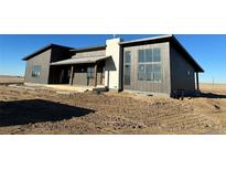 Newly constructed modern home featuring a large window and attractive two-tone exterior at 65960 E Evans Pl, Byers, CO 80103