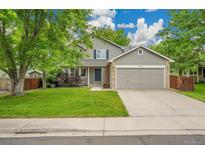 Charming two-story home with a well-manicured lawn, mature trees, and a two-car garage at 2140 W 135Th Ave, Westminster, CO 80234