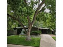 Charming single-story home with mature trees, a stone accent garden, and a welcoming entrance at 1333 S Eudora St, Denver, CO 80222