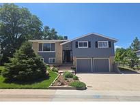 Charming two-story home with a two-car garage and landscaped front yard at 7270 S Cherry Dr, Centennial, CO 80122