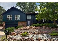 Charming multi-level home featuring stone accents, updated windows and a beautifully landscaped front yard at 14890 W 58Th Pl, Golden, CO 80403