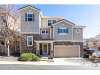 Charming two-story home features a stone facade, attached garage, and well-maintained landscaping at 10120 Fenwick St, Parker, CO 80134