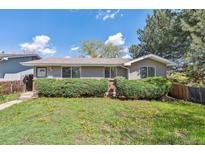 Charming single-story home with a well-maintained lawn and mature trees, offering great curb appeal at 200 Perry St, Denver, CO 80219