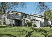 Charming home exterior boasts a lush lawn and a small deck for outdoor enjoyment at 12115 Bannock St # B, Denver, CO 80234